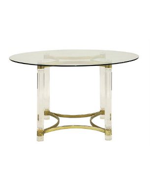 A circular glass, brass and lucite dining table
