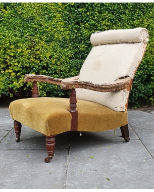A late Victorian walnut open upholstered armchair