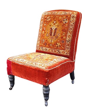 A  late Victorian ebonised 'Carpet' slipper chair