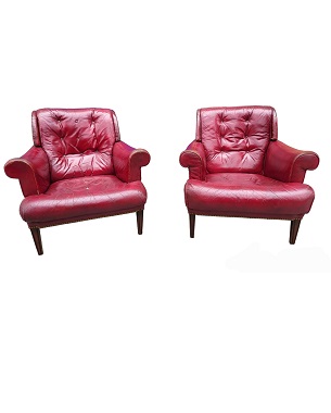 A    pair of cherry red leather armchairs