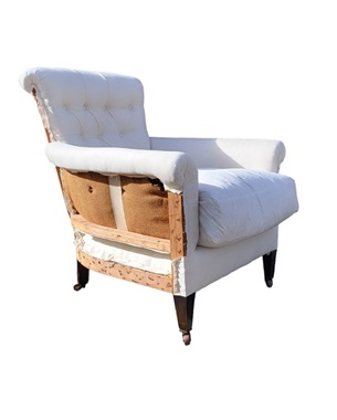 A        Edwardian 'Woodstock' style mahogany upholstered armchair