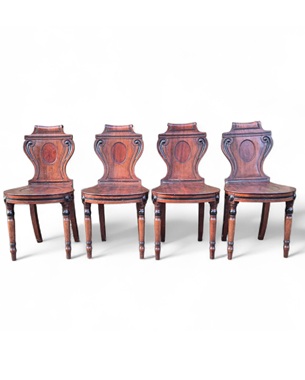 A             set of four mahogany hall chairs