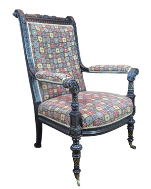 A               pretty Victorian ebonised and gilded upholstered library armchair