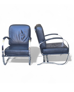 a                         pair of chrome and leather open armchairs after Kem Weber